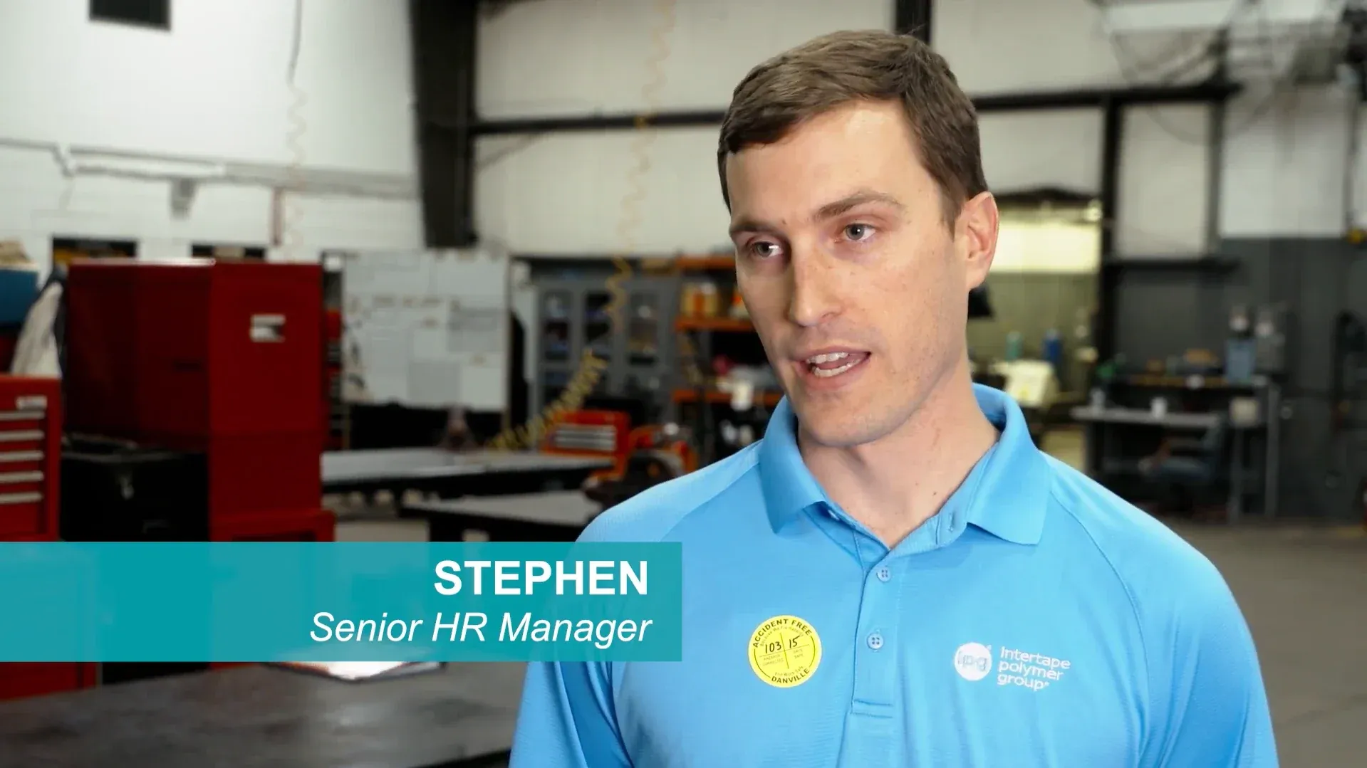 Stephen, Senior HR Manager, speaking on a factory floor in an Intertape Polymer Group shirt