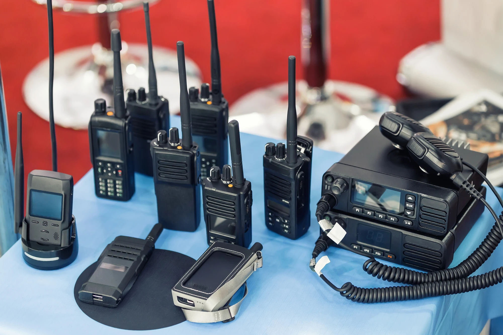 Assortment of handheld two-way radios and mobile radios displayed on a table