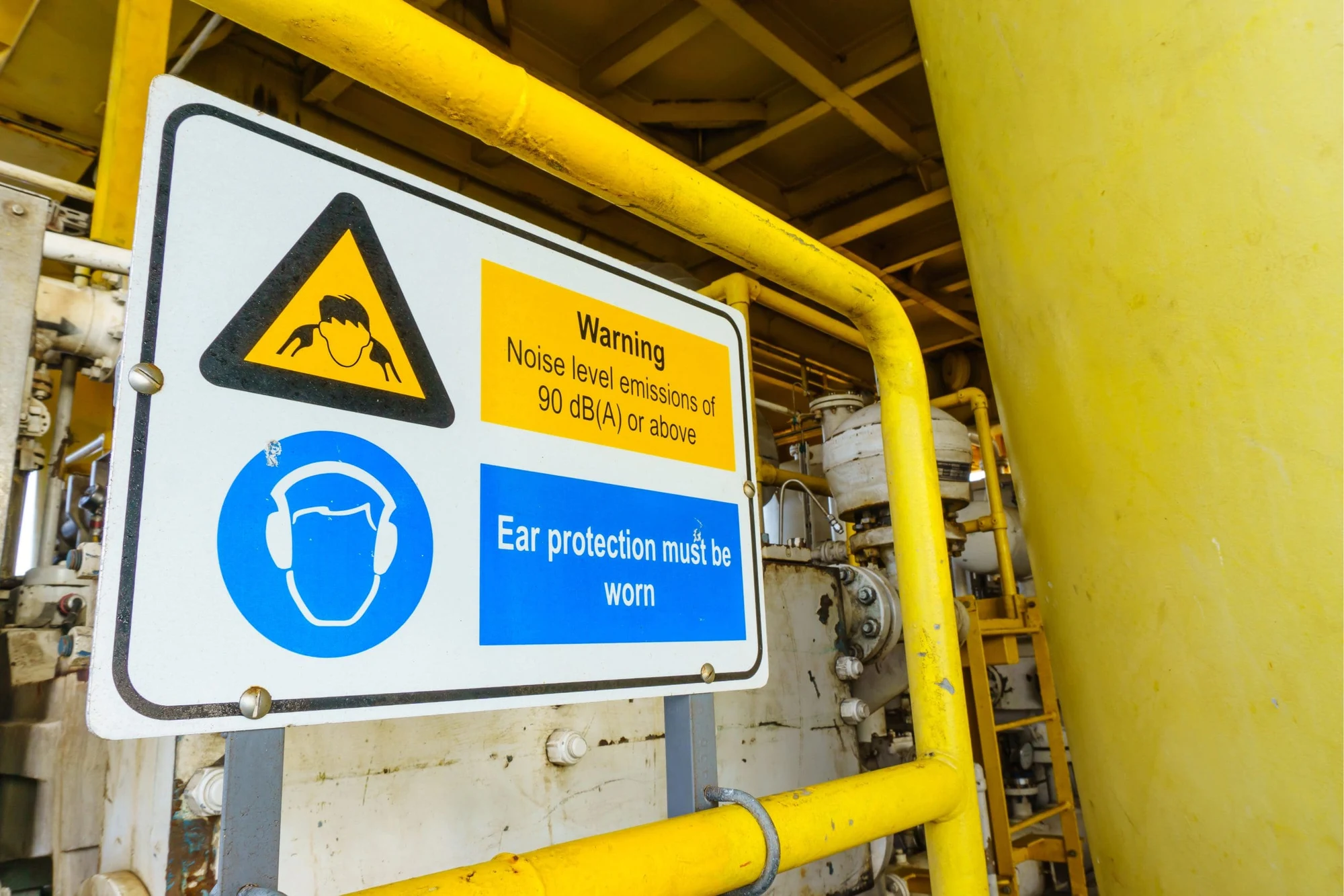 Warning sign for noise levels of 90 dB(A) or above stating ear protection must be worn